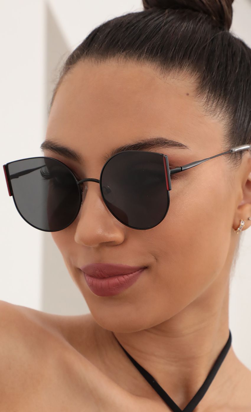 Picture Oversized Slim Metal Cat Eye Sunglasses in Black. Source: https://media-img.lucyinthesky.com/data/Mar21_2/850xAUTO/AT2A0330.JPG