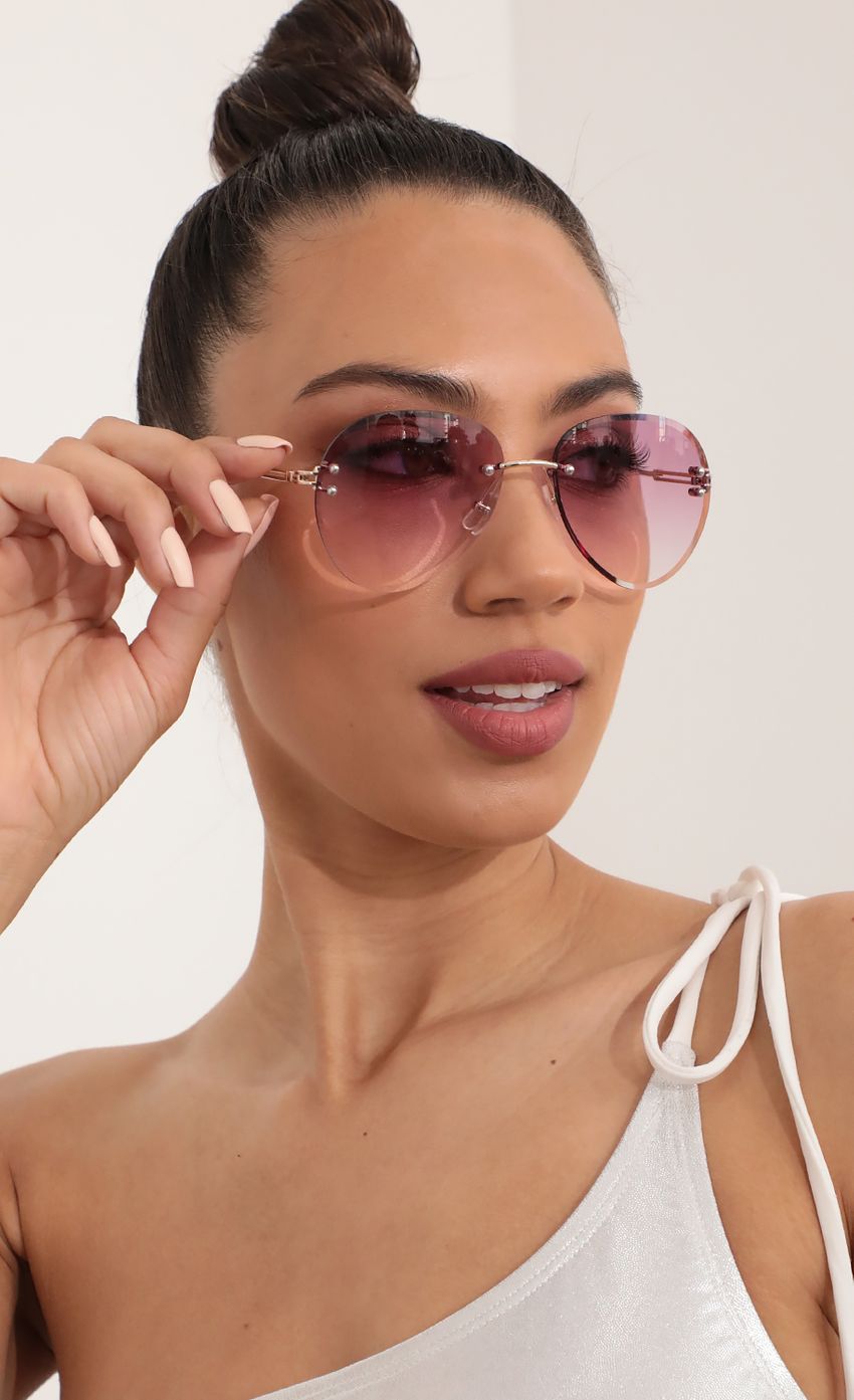 Picture Rimless Aviator-Inspired Sunglasses in Magenta. Source: https://media-img.lucyinthesky.com/data/Mar21_2/850xAUTO/AT2A0546_COPY.JPG