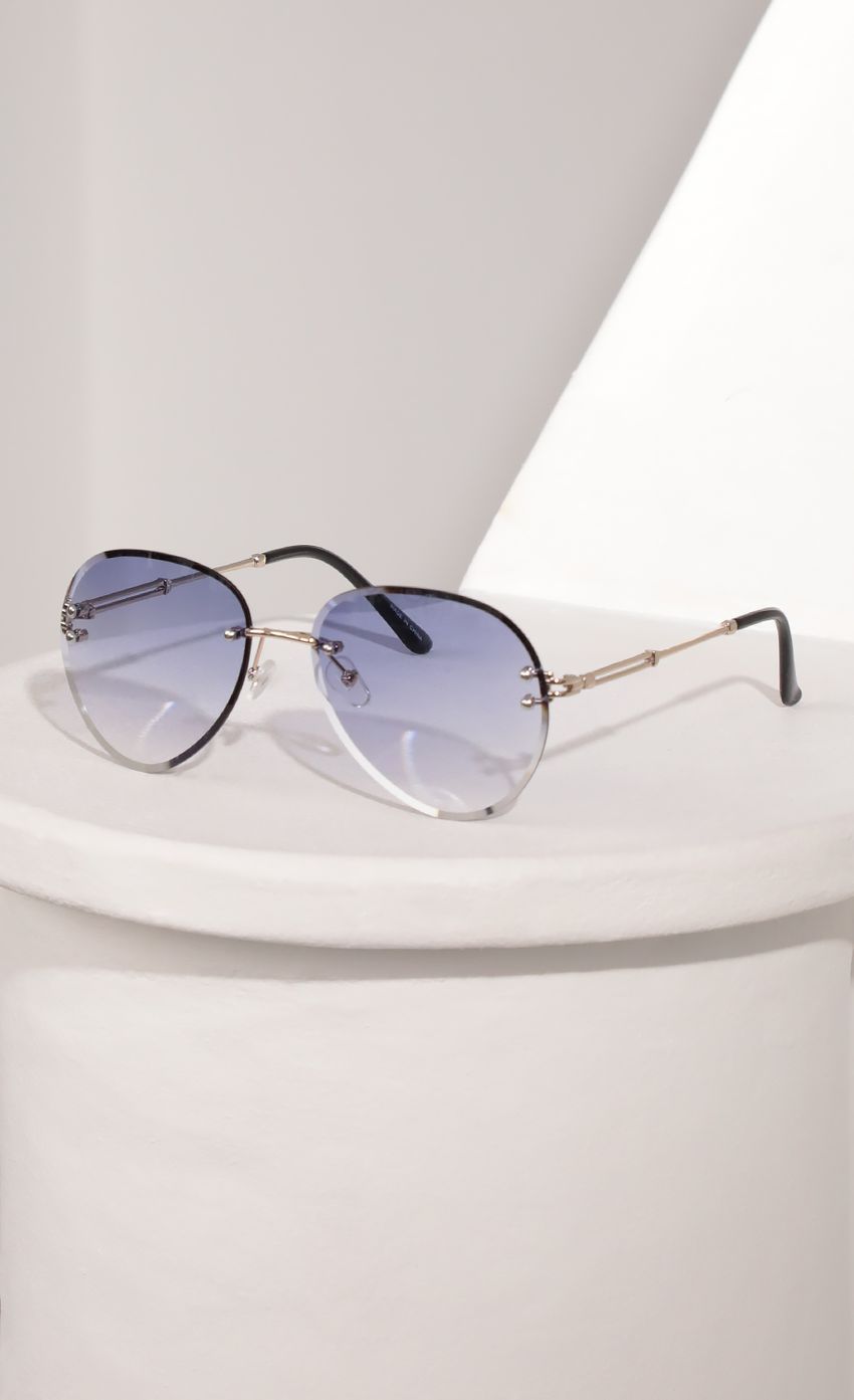 Picture Rimless Aviator-Inspired Sunglasses in Lavender. Source: https://media-img.lucyinthesky.com/data/Mar21_2/850xAUTO/AT2A9384.JPG