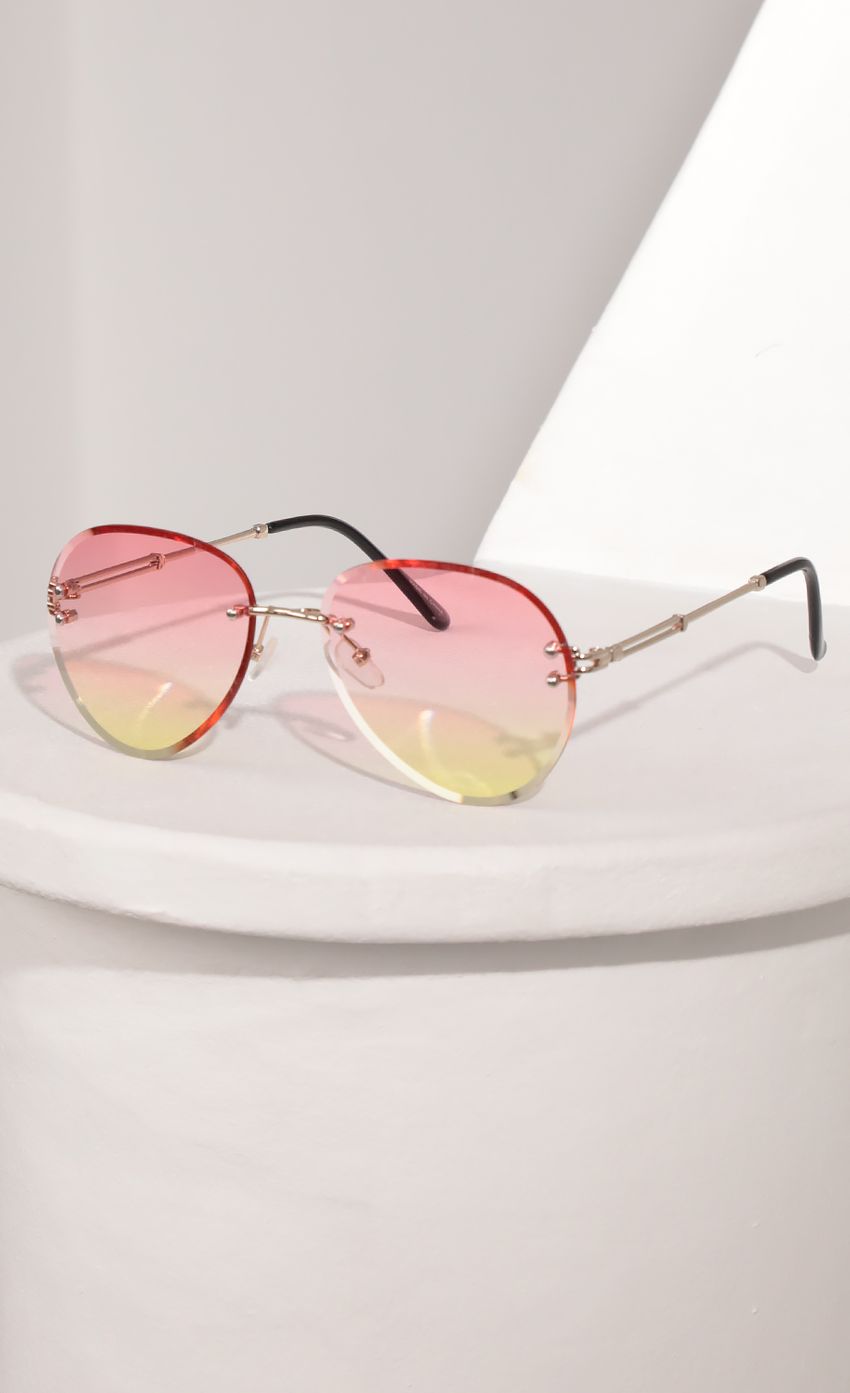 Picture Rimless Aviator-Inspired Sunglasses in Pink Ombre. Source: https://media-img.lucyinthesky.com/data/Mar21_2/850xAUTO/AT2A9387_COPY.PSD