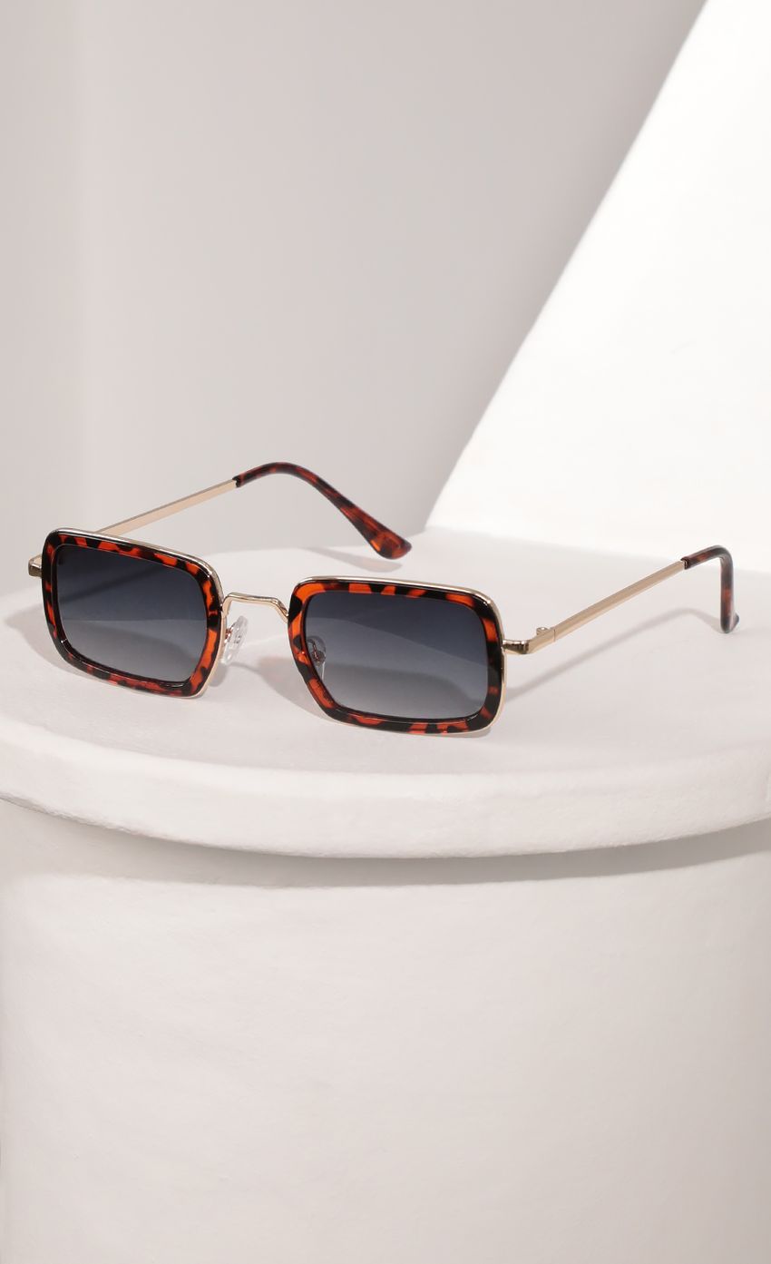 Picture Rectangle Sunglasses with Brown Tortoise Bevelled Edge Lenses. Source: https://media-img.lucyinthesky.com/data/Mar21_2/850xAUTO/AT2A9406.JPG