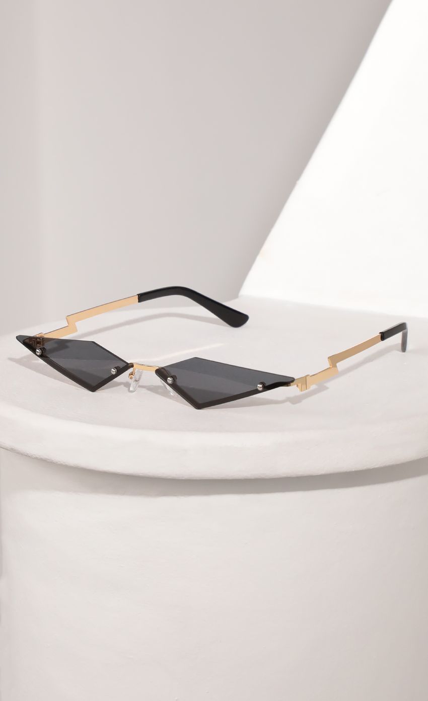 Picture Rimless Micro Cat Eye Sunglasses in Black. Source: https://media-img.lucyinthesky.com/data/Mar21_2/850xAUTO/AT2A9466.JPG