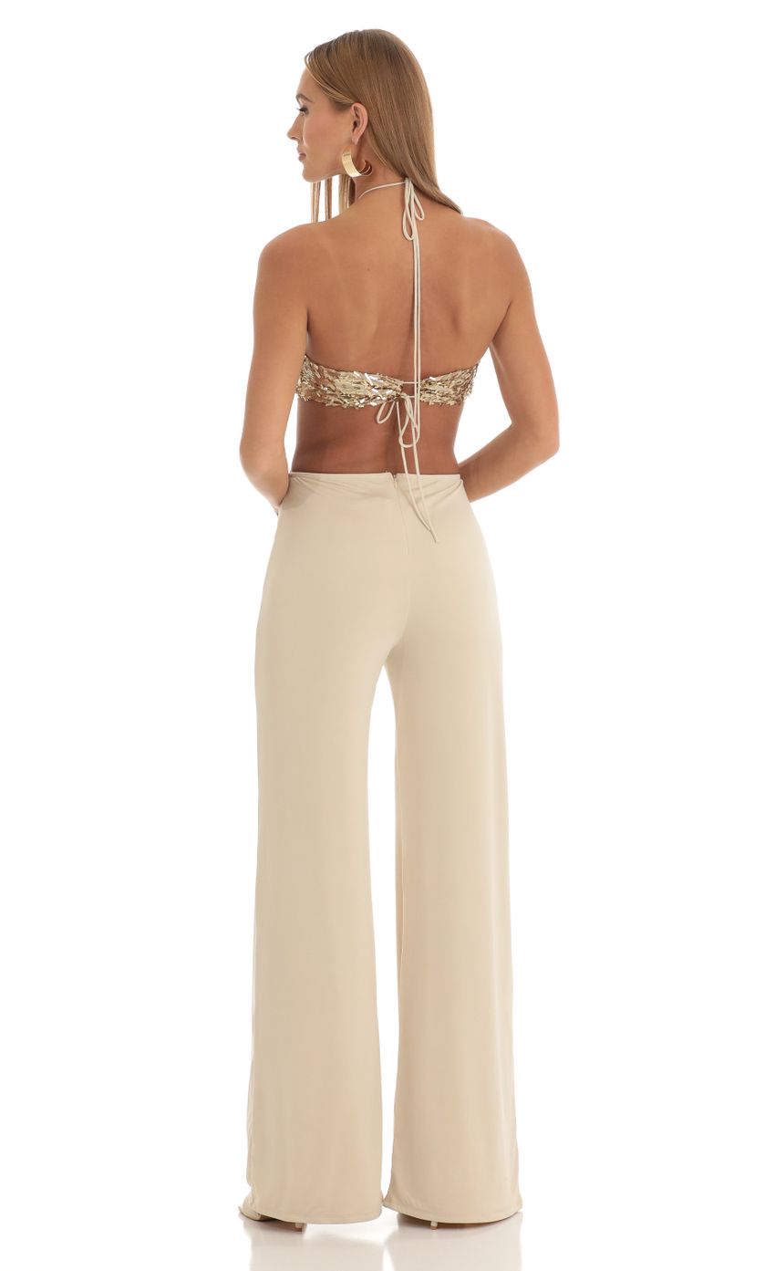 Picture Gold Sequin Halter Jumpsuit in Beige. Source: https://media-img.lucyinthesky.com/data/Mar23/850xAUTO/23eac4cf-543f-4ae5-b9ec-4711a35c117a.jpg