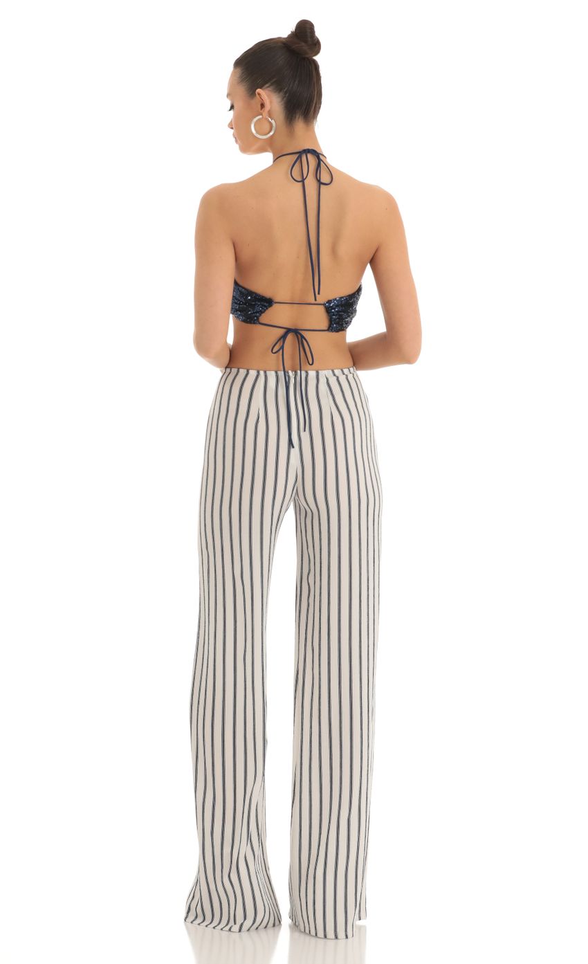 Picture Sequin Halter Striped Jumpsuit in White and Navy. Source: https://media-img.lucyinthesky.com/data/Mar23/850xAUTO/7765bdaa-16db-442d-a980-22988a828891.jpg