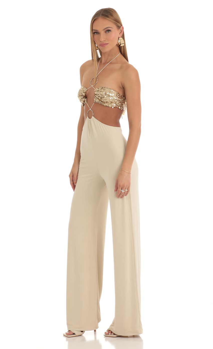 Picture Gold Sequin Halter Jumpsuit in Beige. Source: https://media-img.lucyinthesky.com/data/Mar23/850xAUTO/dea4d825-9e05-4205-b2e6-9ed32cbb6a36.jpg