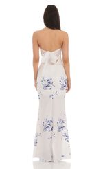 Picture Floral Back Bow Strapless Maxi Dress in White. Source: https://media-img.lucyinthesky.com/data/Mar24/150xAUTO/aaf4c662-ab71-41dc-a11d-83fe663990ea.jpg
