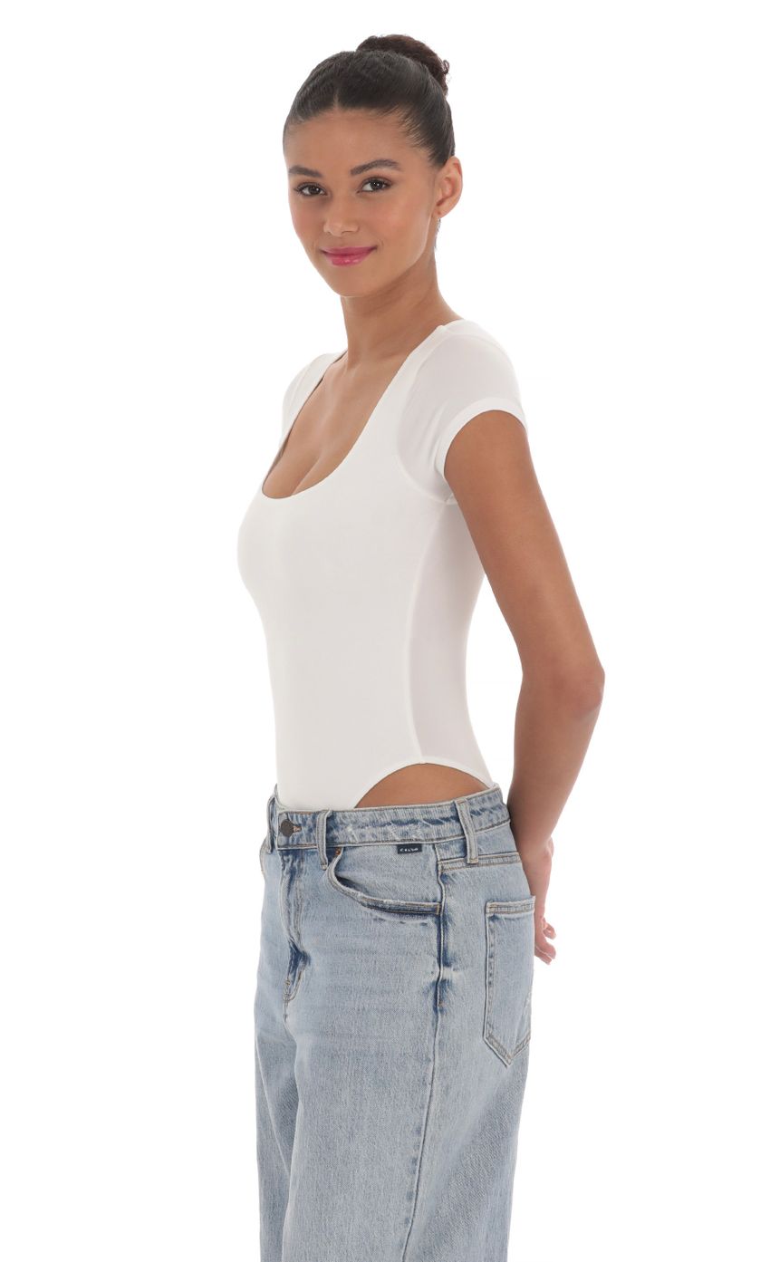 Picture Short Sleeve High Thigh Bodysuit in White. Source: https://media-img.lucyinthesky.com/data/Mar24/850xAUTO/02f4a1c7-b255-4918-8e4a-9ca1a47c512f.jpg
