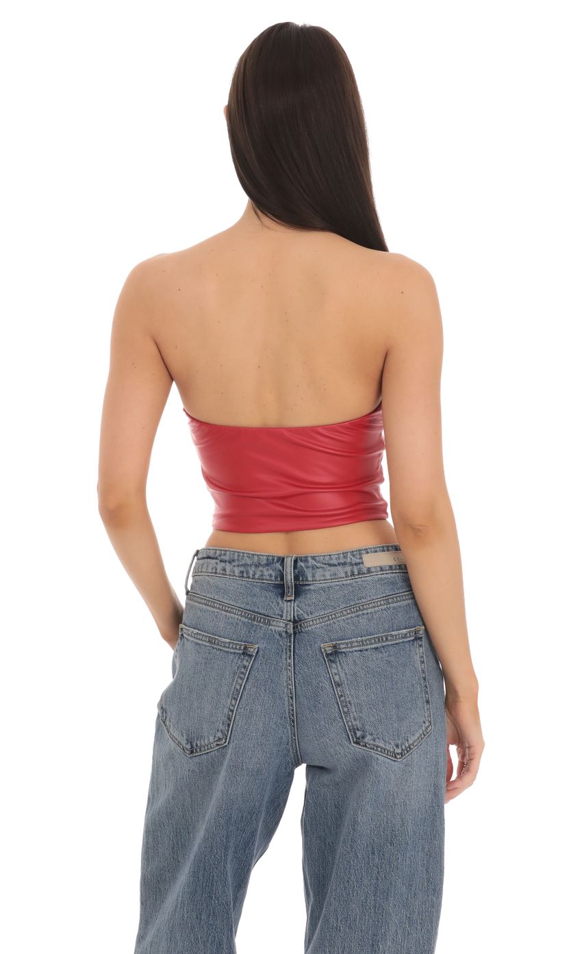 Picture Faux Leather Buckle Top in Red. Source: https://media-img.lucyinthesky.com/data/Mar24/850xAUTO/0b734ed9-5d9a-4fe5-a54a-4d363442f0e6.jpg