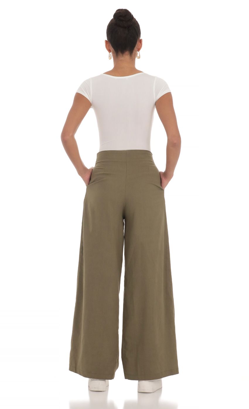 Picture Linen Pleated Pants in Olive. Source: https://media-img.lucyinthesky.com/data/Mar24/850xAUTO/120a6b53-2887-4309-9965-755f6dcc9380.jpg