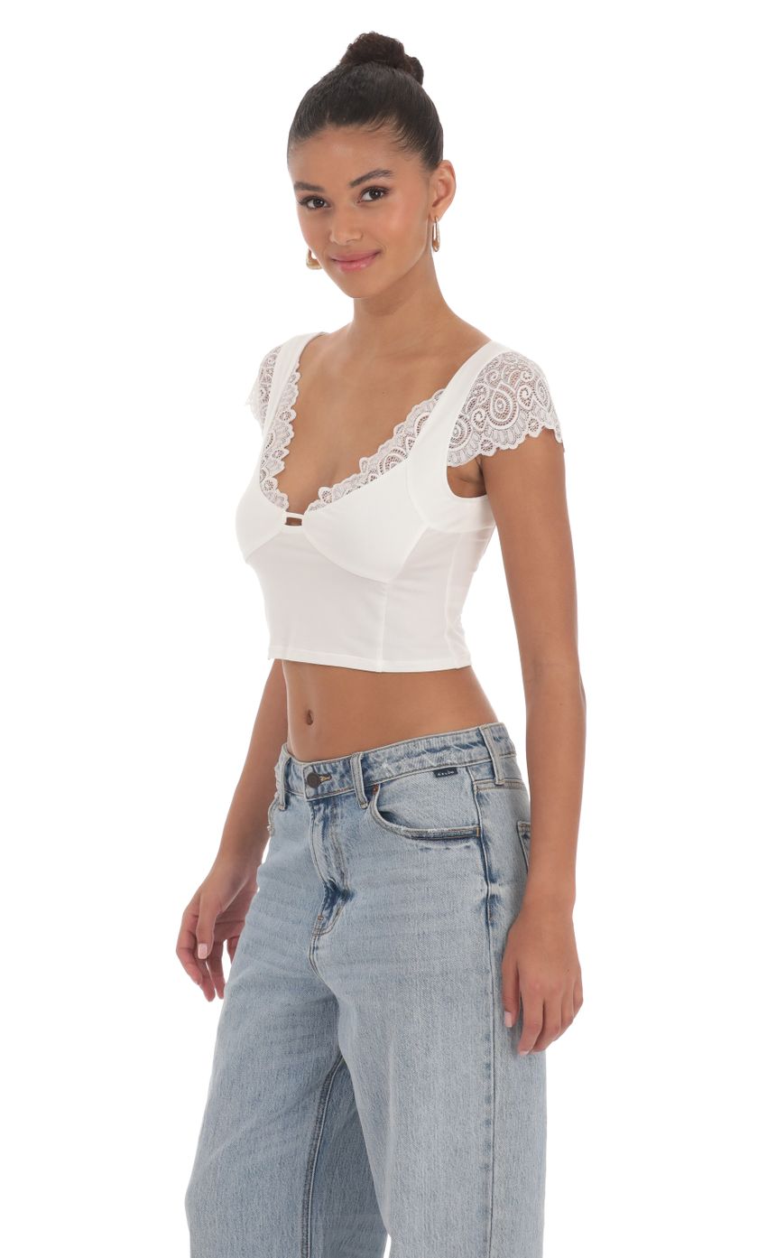 Picture Lace Sleeve Top in White. Source: https://media-img.lucyinthesky.com/data/Mar24/850xAUTO/84554478-3581-4336-b3ba-3080edf8ee45.jpg