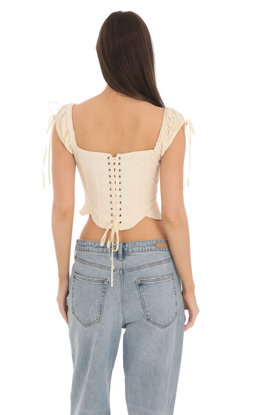 Picture Puff Sleeve Corset Top in Cream. Source: https://media-img.lucyinthesky.com/data/Mar24/850xAUTO/c1a70d8e-0b5a-4dd5-8a4d-83d1daed1f3c.jpg