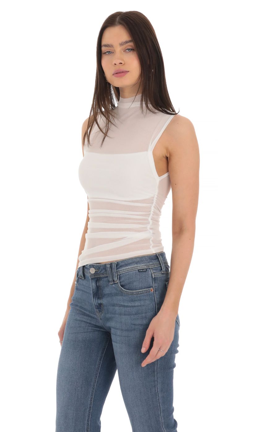 Picture Mesh Mock Neck Top in White. Source: https://media-img.lucyinthesky.com/data/Mar24/850xAUTO/dbdd50ab-3b72-4204-9982-25ea68249b87.jpg