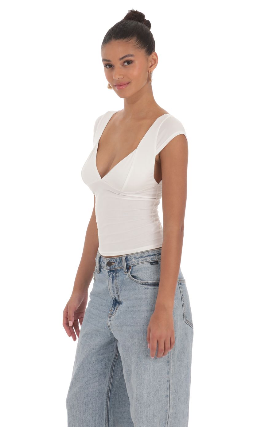 Picture Short Sleeve V-Neck Top in White. Source: https://media-img.lucyinthesky.com/data/Mar24/850xAUTO/ee3b4bff-29a4-4814-91b1-7b8fa408c79f.jpg
