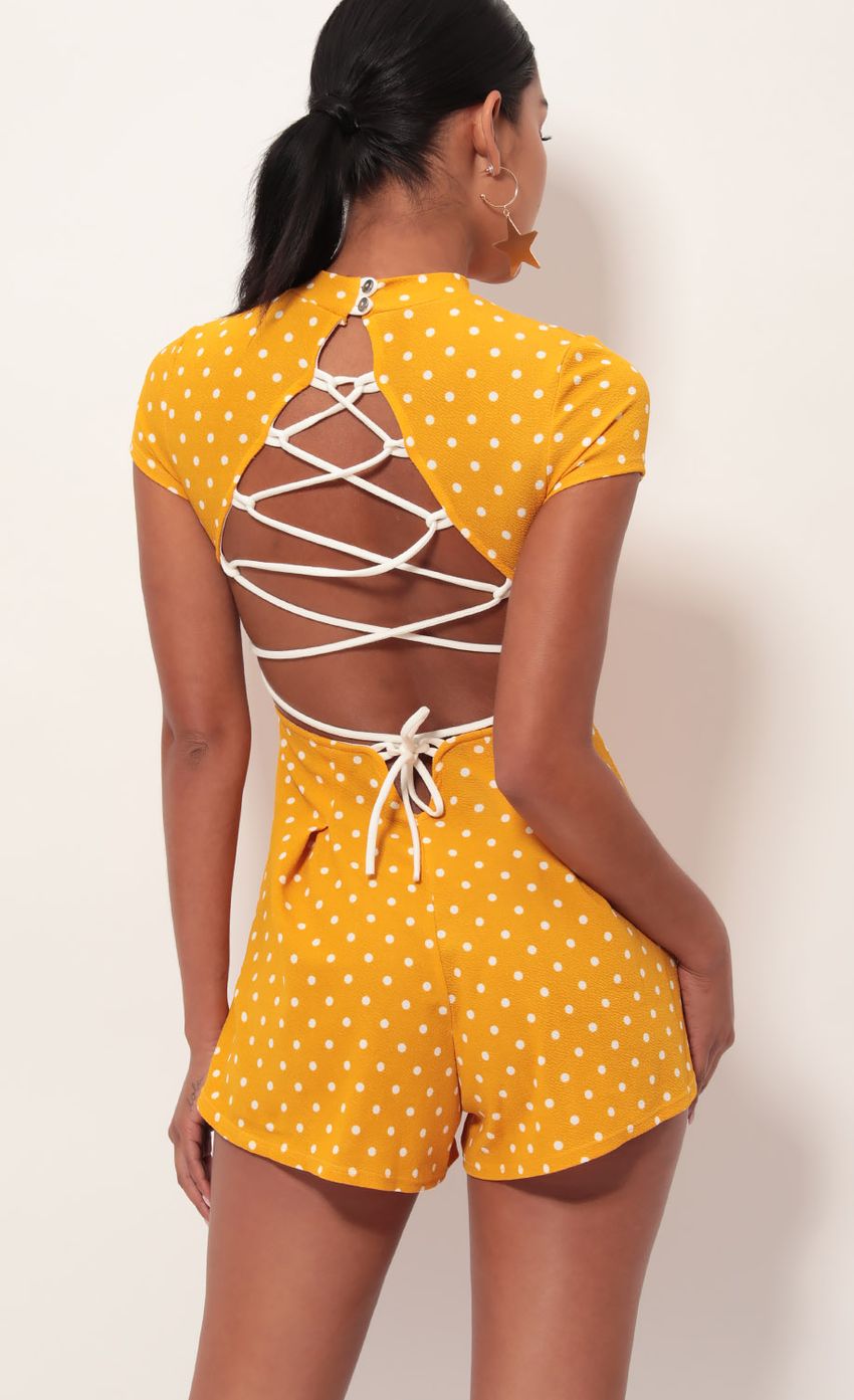 Picture Gaia High Neck Romper In Yellow Polka Dot. Source: https://media-img.lucyinthesky.com/data/May19_2/850xAUTO/781A8731.JPG