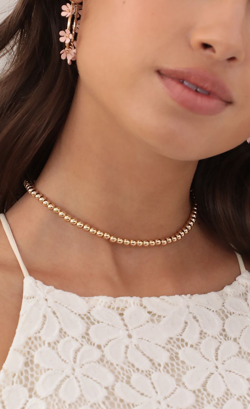 Picture Gold Ball Choker Necklace. Source: https://media-img.lucyinthesky.com/data/May21_1/850xAUTO/AT2A3888.JPG