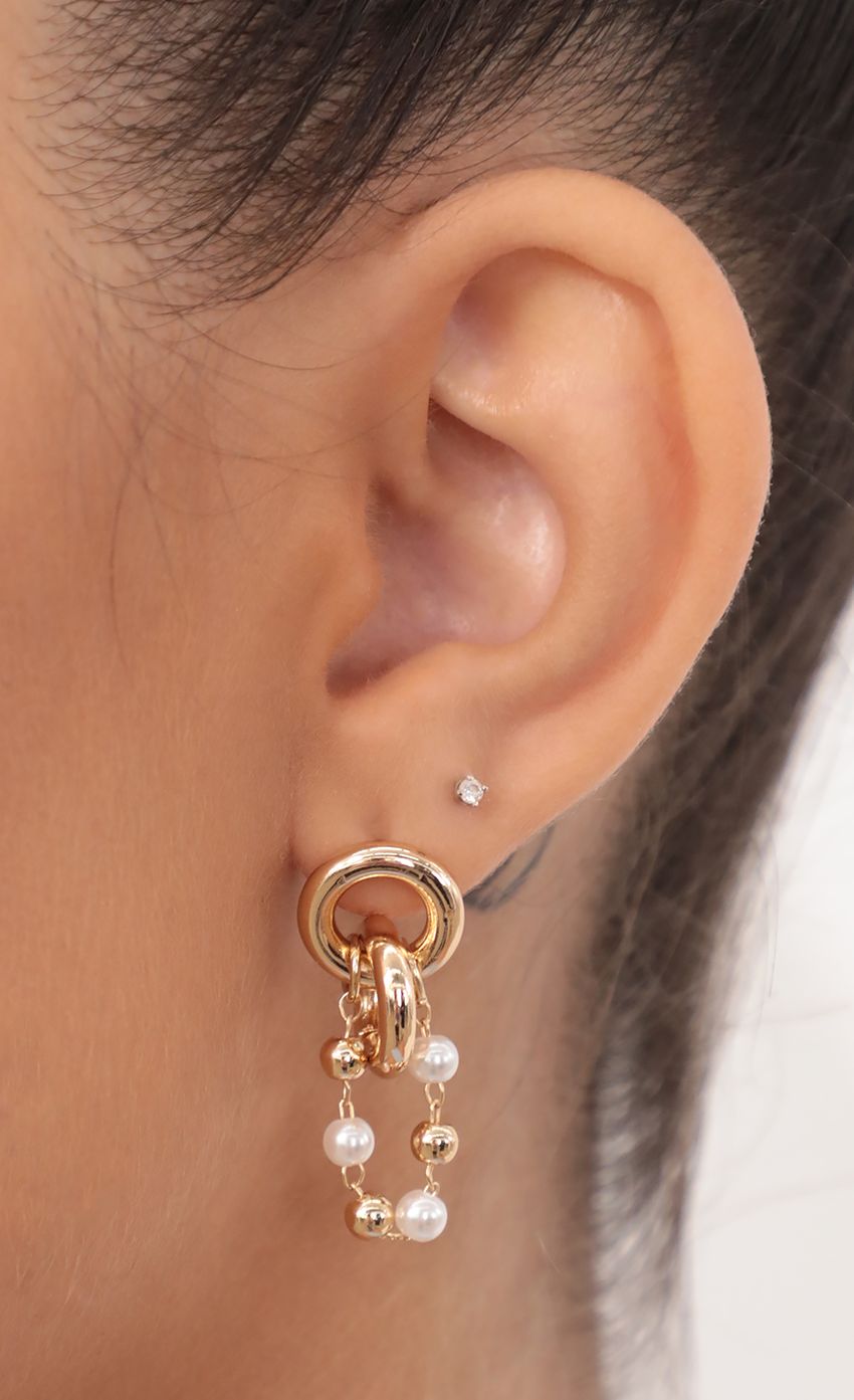 Picture Interlocking Double Circle Stud Earrings With Pearl Chain. Source: https://media-img.lucyinthesky.com/data/May21_2/850xAUTO/AT2A0758_COPY.JPG