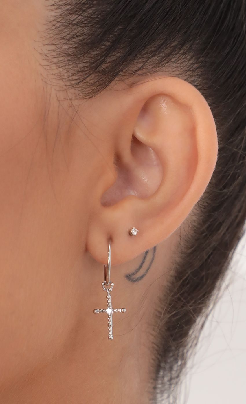 Picture Crystal Cross Hoops in Silver. Source: https://media-img.lucyinthesky.com/data/May21_2/850xAUTO/AT2A1210.JPG