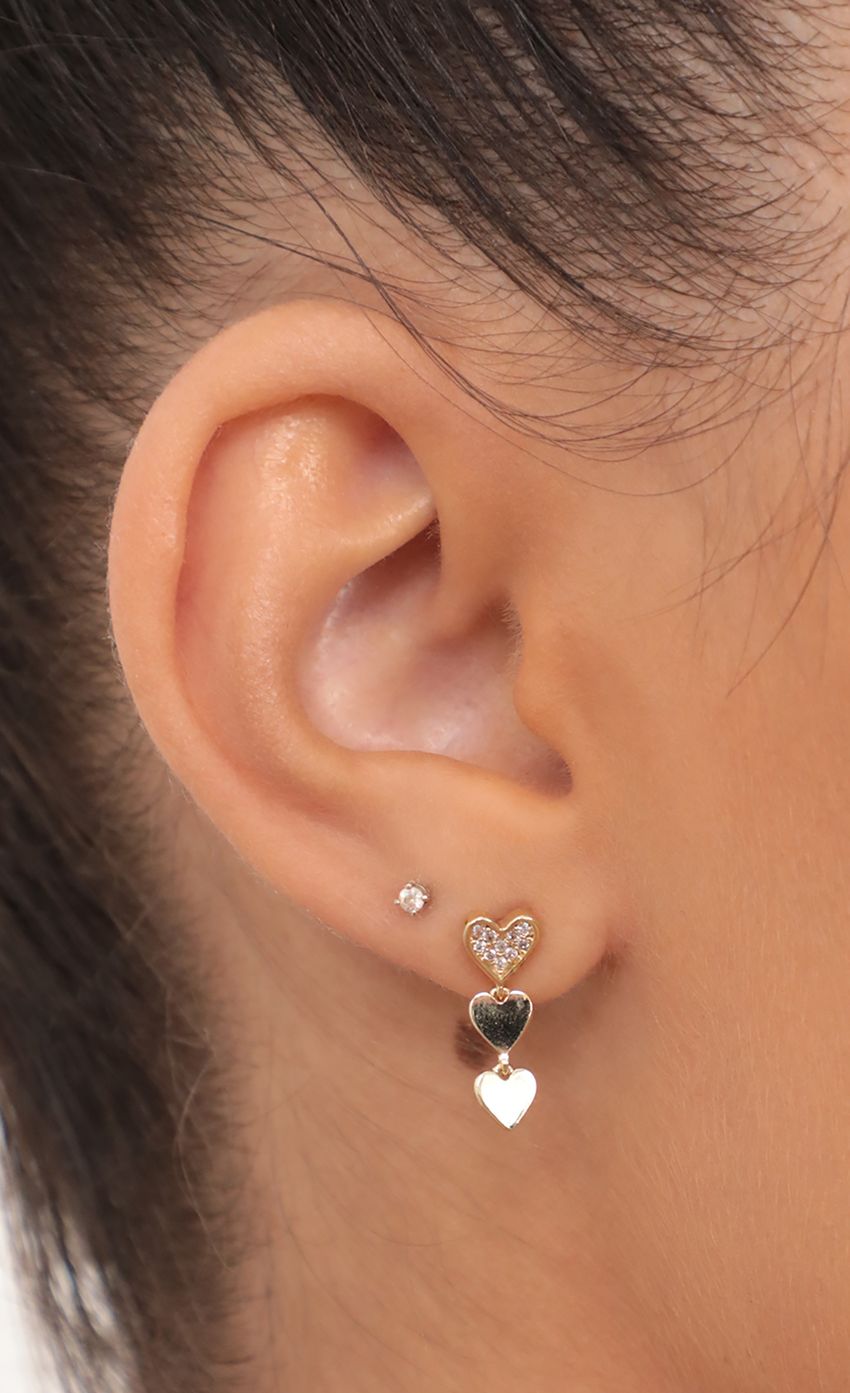 Picture Dangling Mini Heart Stud Earrings in Gold. Source: https://media-img.lucyinthesky.com/data/May21_2/850xAUTO/AT2A1770.JPG