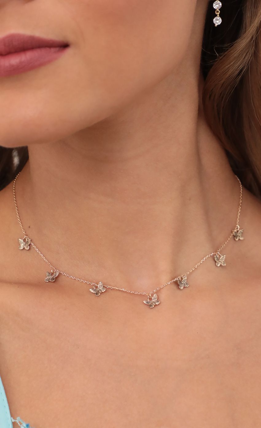Picture Dangly Butterfly Charms Necklace in Gold. Source: https://media-img.lucyinthesky.com/data/May21_2/850xAUTO/AT2A6744.JPG