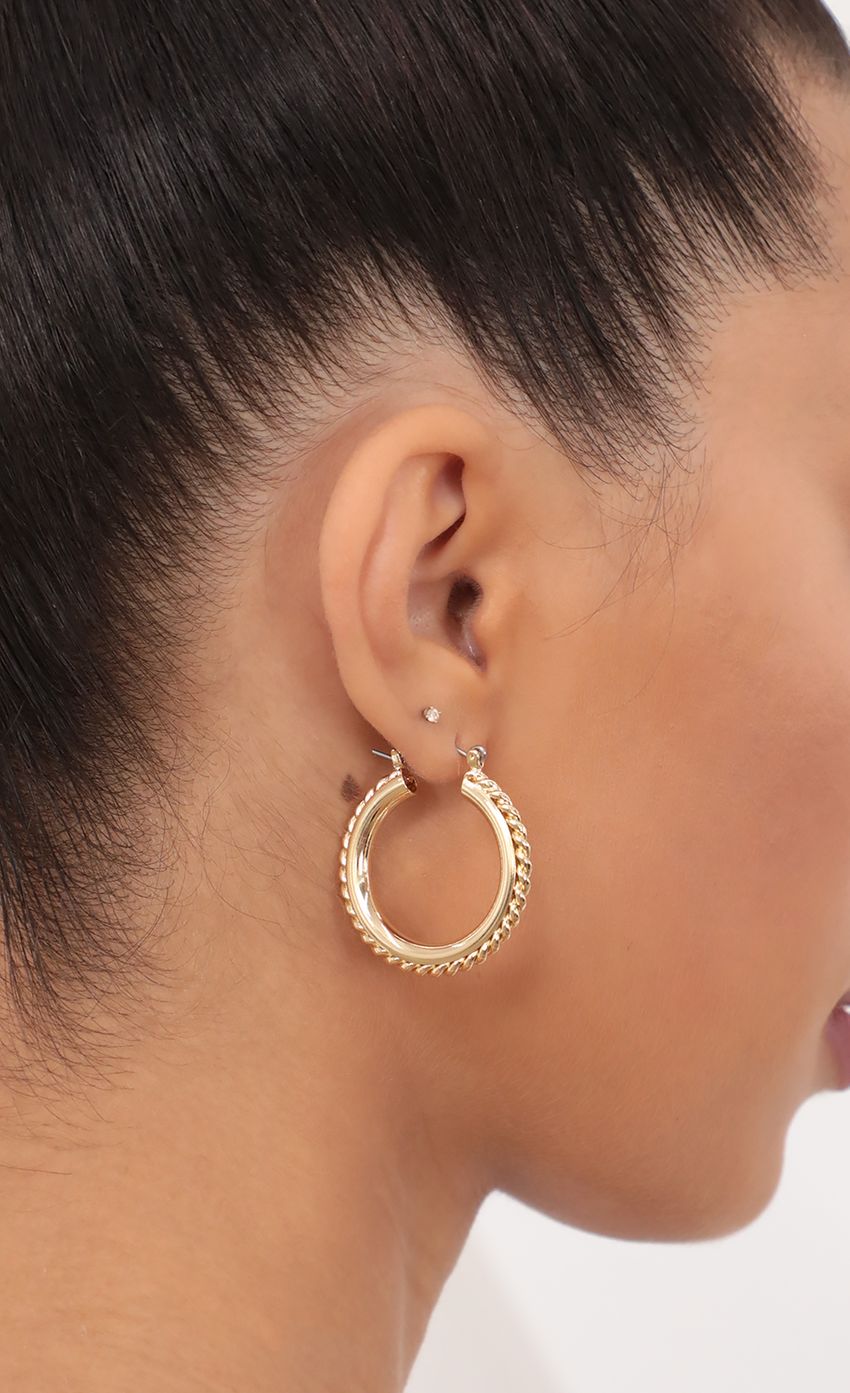 Picture Double Layered Hoop With A Twisted Outer Edge in Gold. Source: https://media-img.lucyinthesky.com/data/May21_2/850xAUTO/AT2A9071.JPG