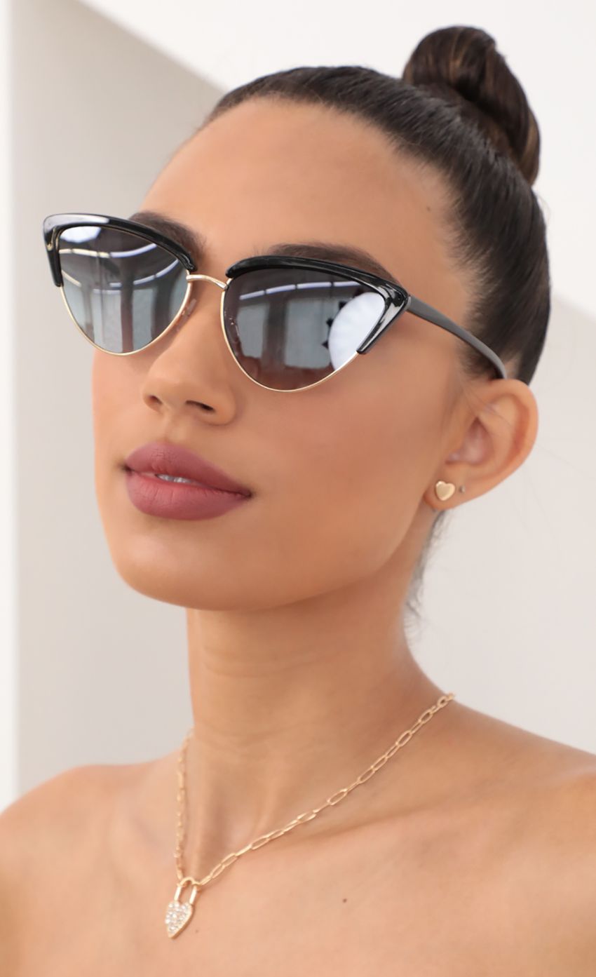 Picture Hollywood Cat-Eye Sunglasses in Black. Source: https://media-img.lucyinthesky.com/data/May21_2/850xAUTO/AT2A9435.JPG