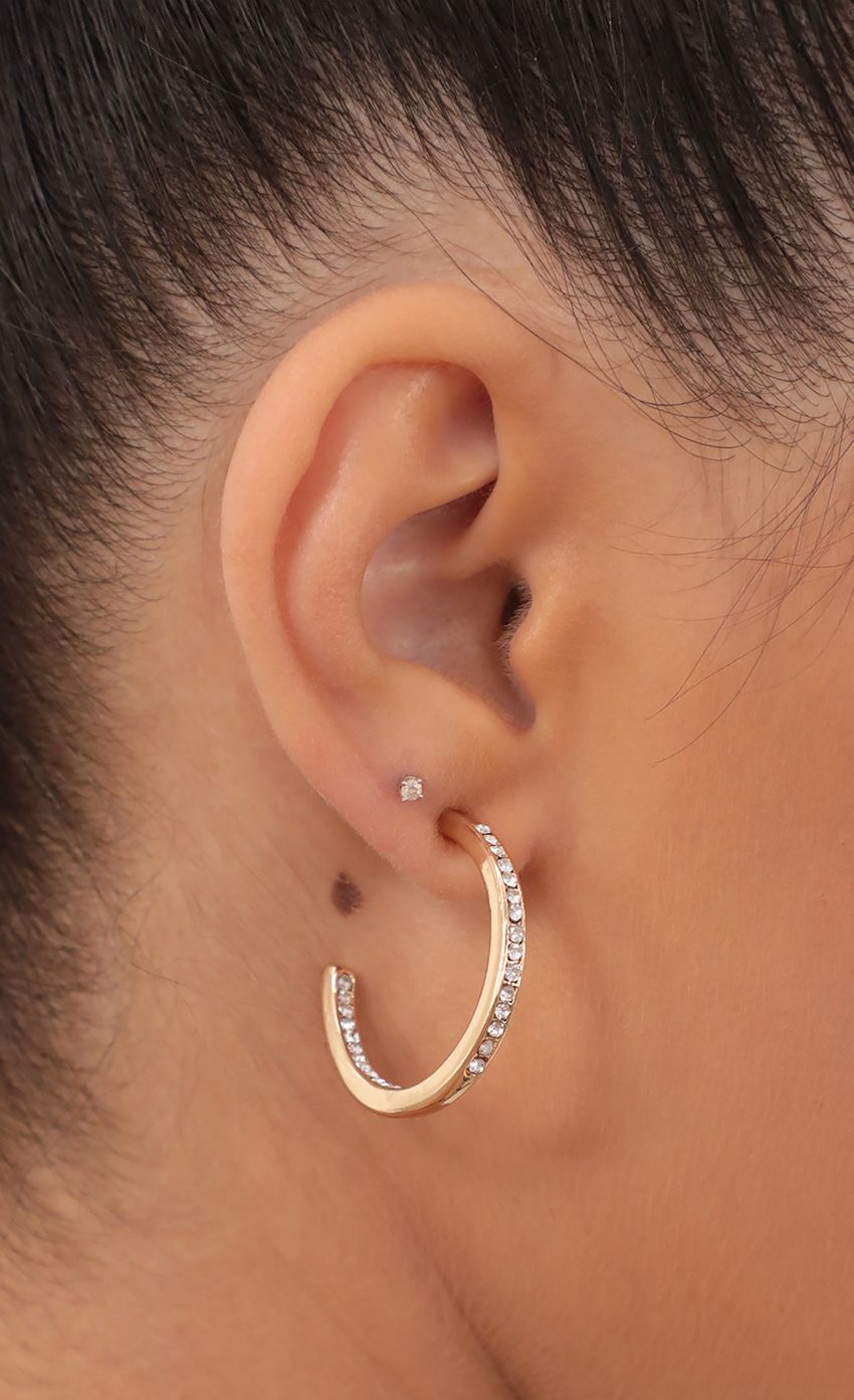 Picture Medium Crystal-Embellished Open Hoops. Source: https://media-img.lucyinthesky.com/data/May21_2/850xAUTO/AT2A9987.JPG