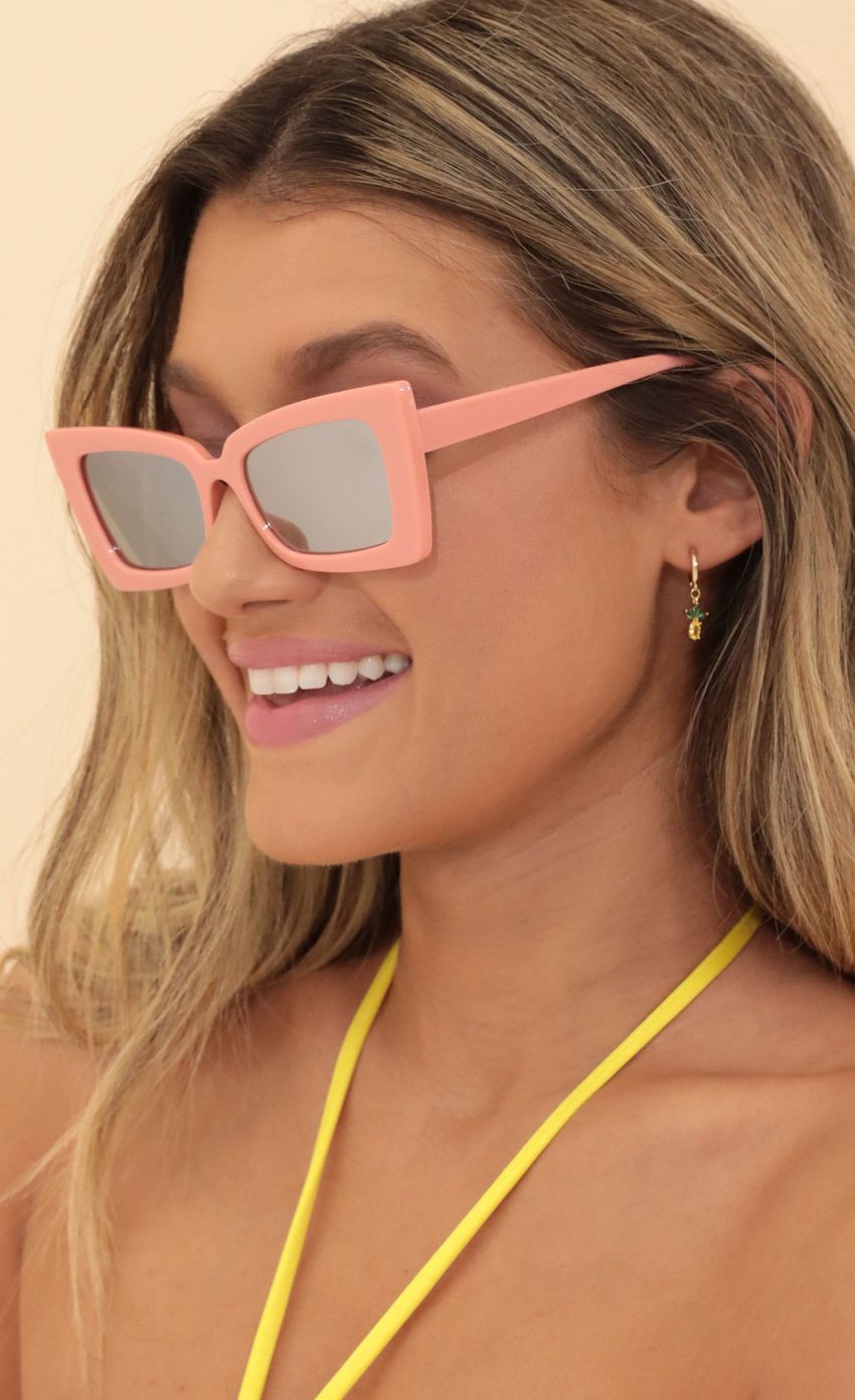 Picture Time for Sunshine Sunglasses in Pink. Source: https://media-img.lucyinthesky.com/data/May22_1/850xAUTO/1V9A4032.JPG