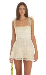 Picture Shimmer Yellow Floral Mini Dress in White. Source: https://media-img.lucyinthesky.com/data/May23/150xAUTO/a753988c-829f-4021-a809-2a6599ec6123.jpg