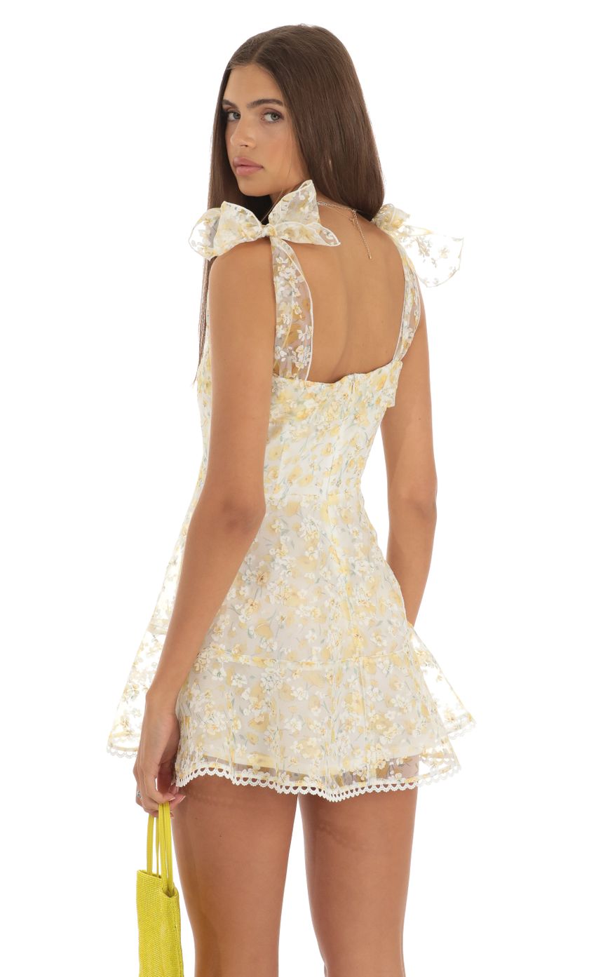 Picture Shimmer Yellow Floral Mini Dress in White. Source: https://media-img.lucyinthesky.com/data/May23/850xAUTO/3769e22d-940f-4738-aec1-535e175b38cc.jpg