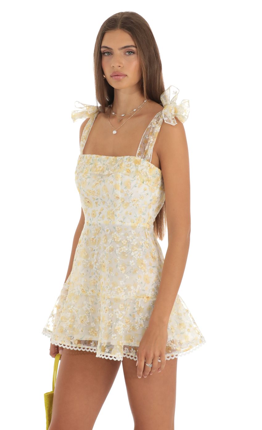 Picture Shimmer Yellow Floral Mini Dress in White. Source: https://media-img.lucyinthesky.com/data/May23/850xAUTO/65edbbaa-d924-4daa-8a50-74fc5bd19354.jpg