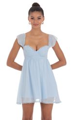 Picture Shimmer Embroidered Trim Babydoll Dress in Blue. Source: https://media-img.lucyinthesky.com/data/May24/150xAUTO/15ecb4b1-31e3-4126-b60b-9450254a839d.jpg