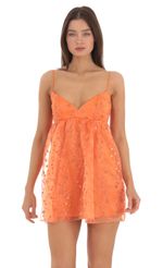 Picture Sequin Floral Babydoll Dress in Orange. Source: https://media-img.lucyinthesky.com/data/May24/150xAUTO/8b5744f4-aa67-47cd-bc86-2225565de3e1.jpg