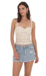Picture Floral Strap Eyelet Top in White and Yellow. Source: https://media-img.lucyinthesky.com/data/May24/150xAUTO/f38cf4cc-c251-4f5f-bdf7-a04c2d92b1c4.jpg