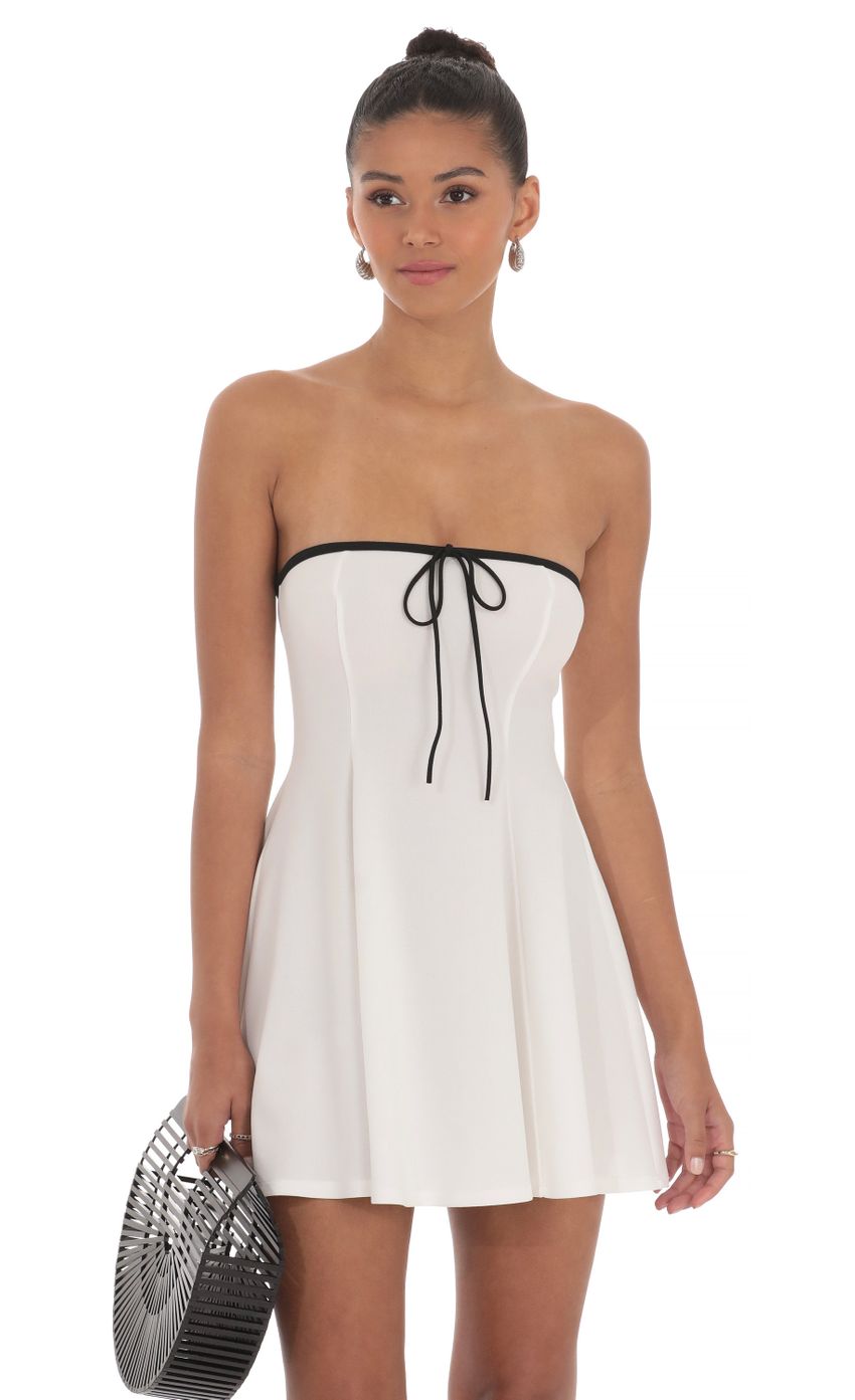 Picture Black Trim Fit and Flare Dress in White. Source: https://media-img.lucyinthesky.com/data/May24/850xAUTO/96af332b-b8af-47a8-9997-da879f647415.jpg