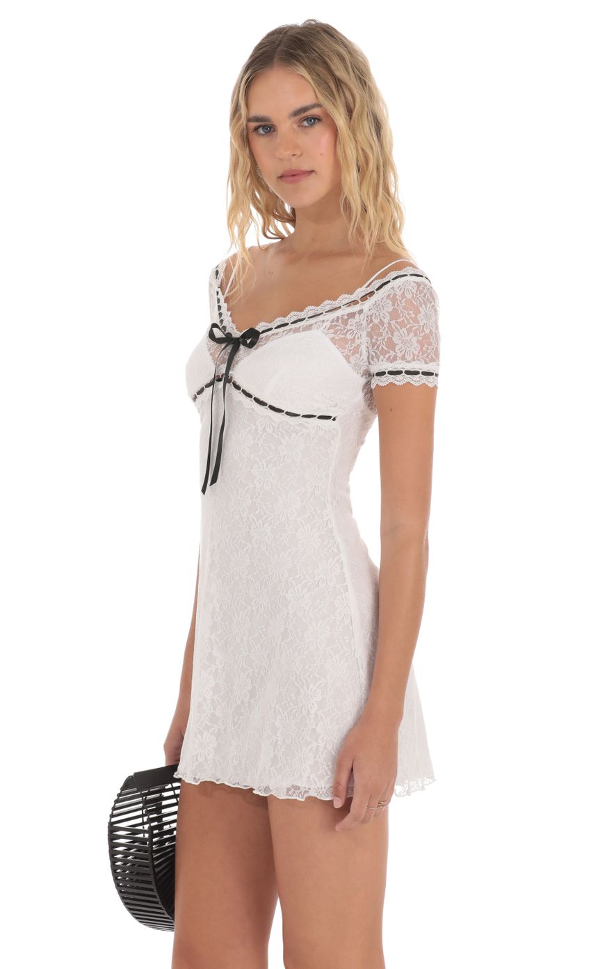 Picture Black Ribbon Lace Dress in White. Source: https://media-img.lucyinthesky.com/data/May24/850xAUTO/9a7c97f6-8487-4e44-a33e-6c39ab7007da.jpg