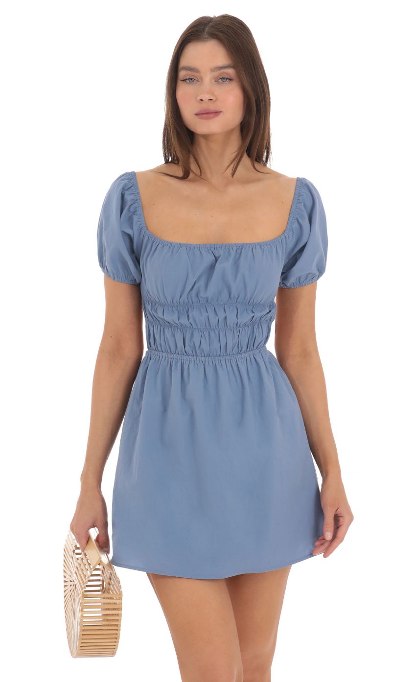 Picture Puff Sleeve Open Back Dress in Denim Blue. Source: https://media-img.lucyinthesky.com/data/May24/850xAUTO/c8a6ffa0-90dc-4c2b-851a-d07c470b9987.jpg