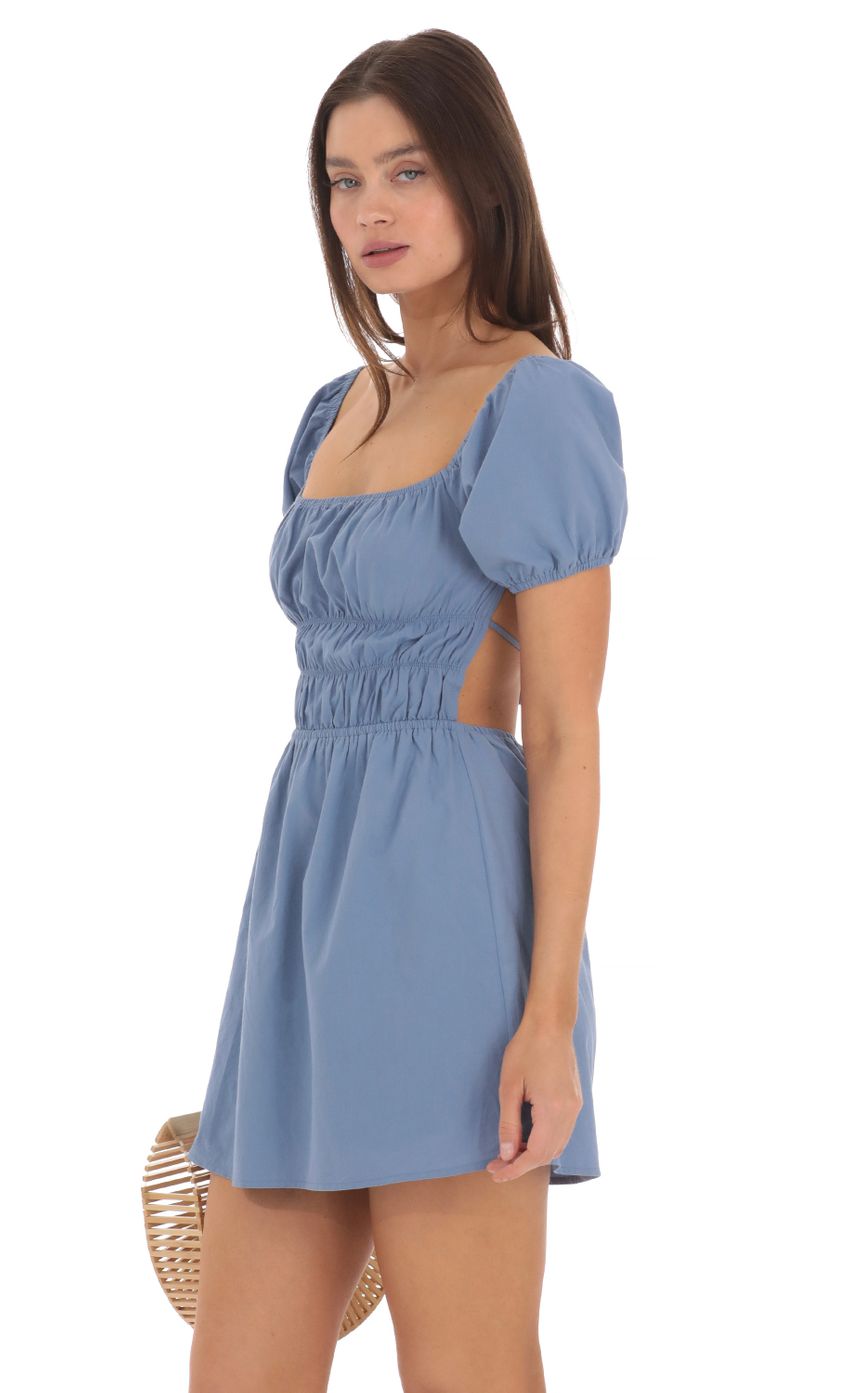 Picture Puff Sleeve Open Back Dress in Denim Blue. Source: https://media-img.lucyinthesky.com/data/May24/850xAUTO/cd8f5299-2b36-402b-a5b1-a249942d9cba.jpg