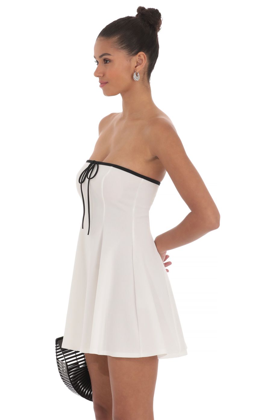 Picture Black Trim Fit and Flare Dress in White. Source: https://media-img.lucyinthesky.com/data/May24/850xAUTO/f1d49aec-fa49-47da-98d0-4098edb859a3.jpg