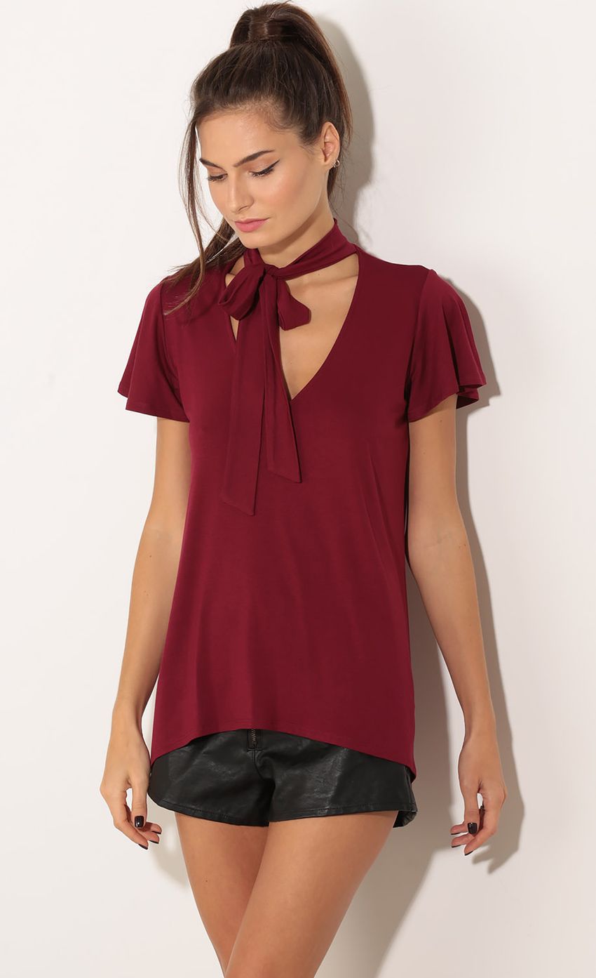 Picture Tie Neck Top in Burgundy. Source: https://media-img.lucyinthesky.com/data/Nov15_2/850xAUTO/0Y5A3557.JPG
