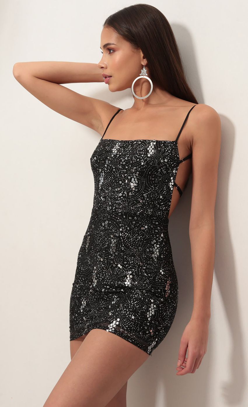 Picture Starstruck Sequin Strappy Dress in Black Starlight. Source: https://media-img.lucyinthesky.com/data/Nov18_2/850xAUTO/0Y5A1944XS.JPG