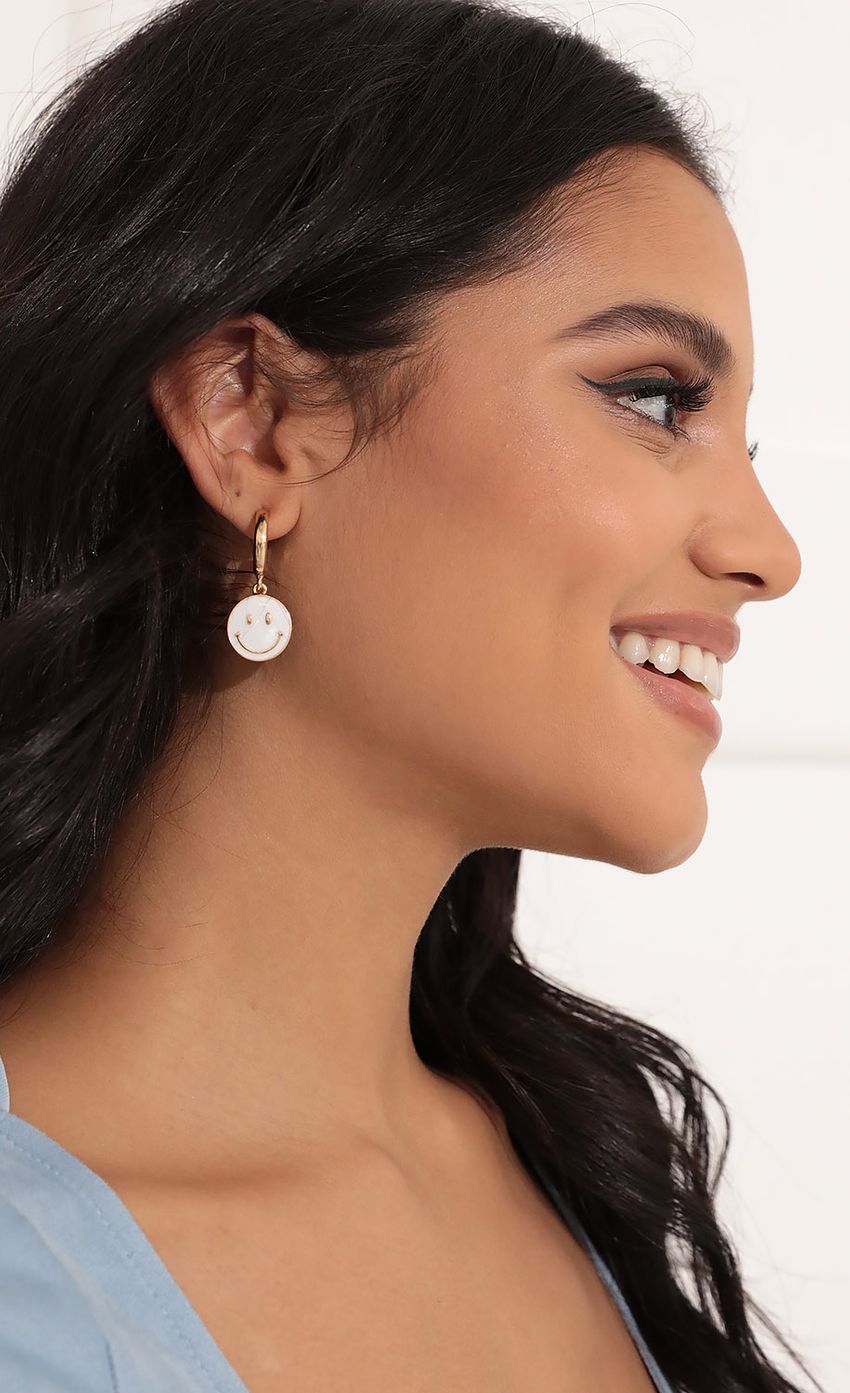 Picture Sweetest Smile Mini Hoop Earring in Gold. Source: https://media-img.lucyinthesky.com/data/Nov21_2/850xAUTO/1V9A8849.JPG