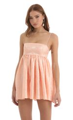 Picture Floral Jacquard Babydoll Dress in Peach. Source: https://media-img.lucyinthesky.com/data/Nov22/150xAUTO/7c0eed7b-2870-4ce6-80f9-8e300087e3d6.jpg