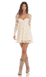 Picture Long Sleeve Lace Babydoll Dress in Cream. Source: https://media-img.lucyinthesky.com/data/Nov23/150xAUTO/0227df99-2e0e-4b1e-965b-49c0dc60546d.jpg