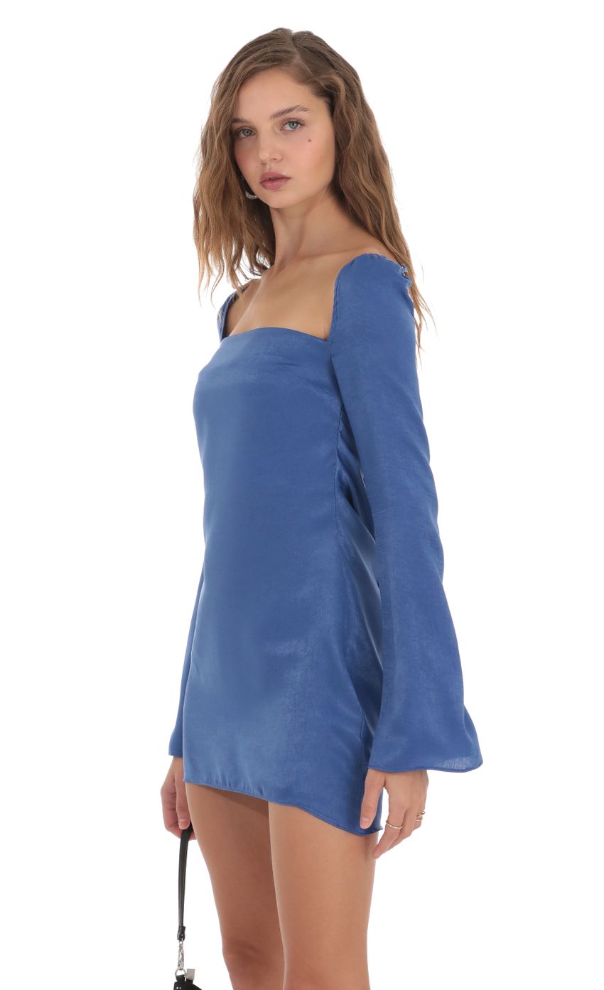 Picture Satin Long Sleeve Open Back Dress in Blue. Source: https://media-img.lucyinthesky.com/data/Nov23/850xAUTO/29d76aca-9fda-4635-b93a-f3c06f02b7b7.jpg