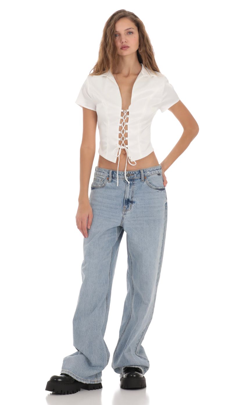 Picture Collared Lace-Up Top in White. Source: https://media-img.lucyinthesky.com/data/Nov23/850xAUTO/30277e75-ee32-4e50-a3ee-5b54b3108336.jpg