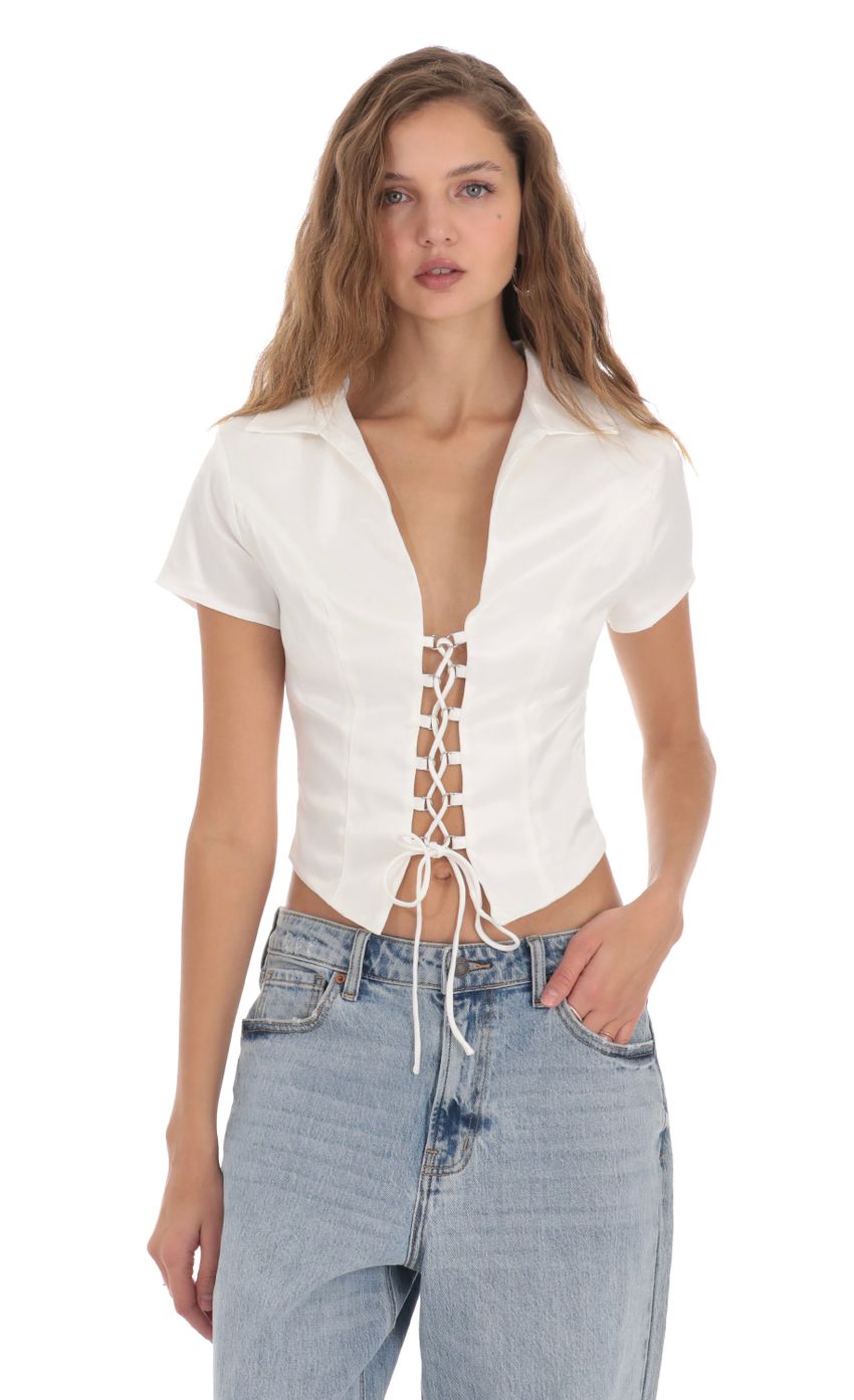 Picture Collared Lace-Up Top in White. Source: https://media-img.lucyinthesky.com/data/Nov23/850xAUTO/e2522a8a-5086-4c6c-8584-9b233138a3ff.jpg