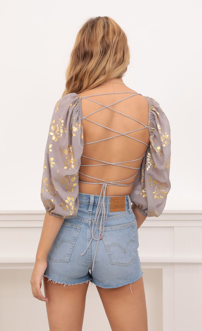 Picture Gold Floral Puff Sleeve Top in Grey. Source: https://media-img.lucyinthesky.com/data/Oct20_1/850xAUTO/1V9A2742.JPG