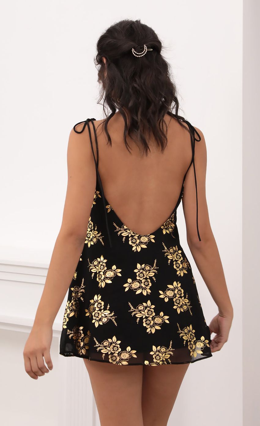 Picture Kiara Gold Floral Chiffon Tie Dress in Black. Source: https://media-img.lucyinthesky.com/data/Oct20_1/850xAUTO/1V9A6197.JPG