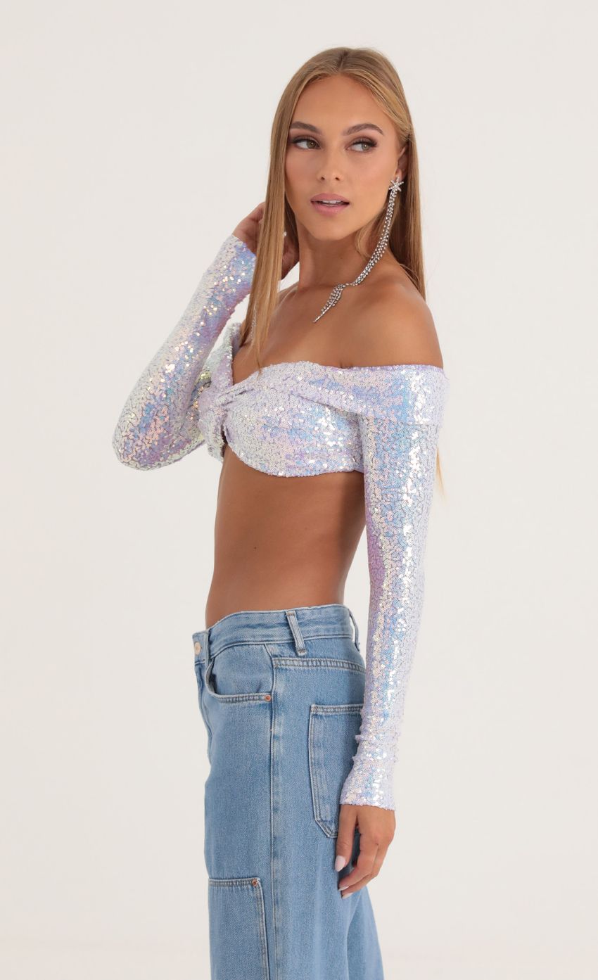 Picture Iridescent Sequin Off The Shoulder Top in Purple. Source: https://media-img.lucyinthesky.com/data/Oct22/850xAUTO/799a4e53-73b9-4c0b-92f6-2d7f40d1c353.jpg