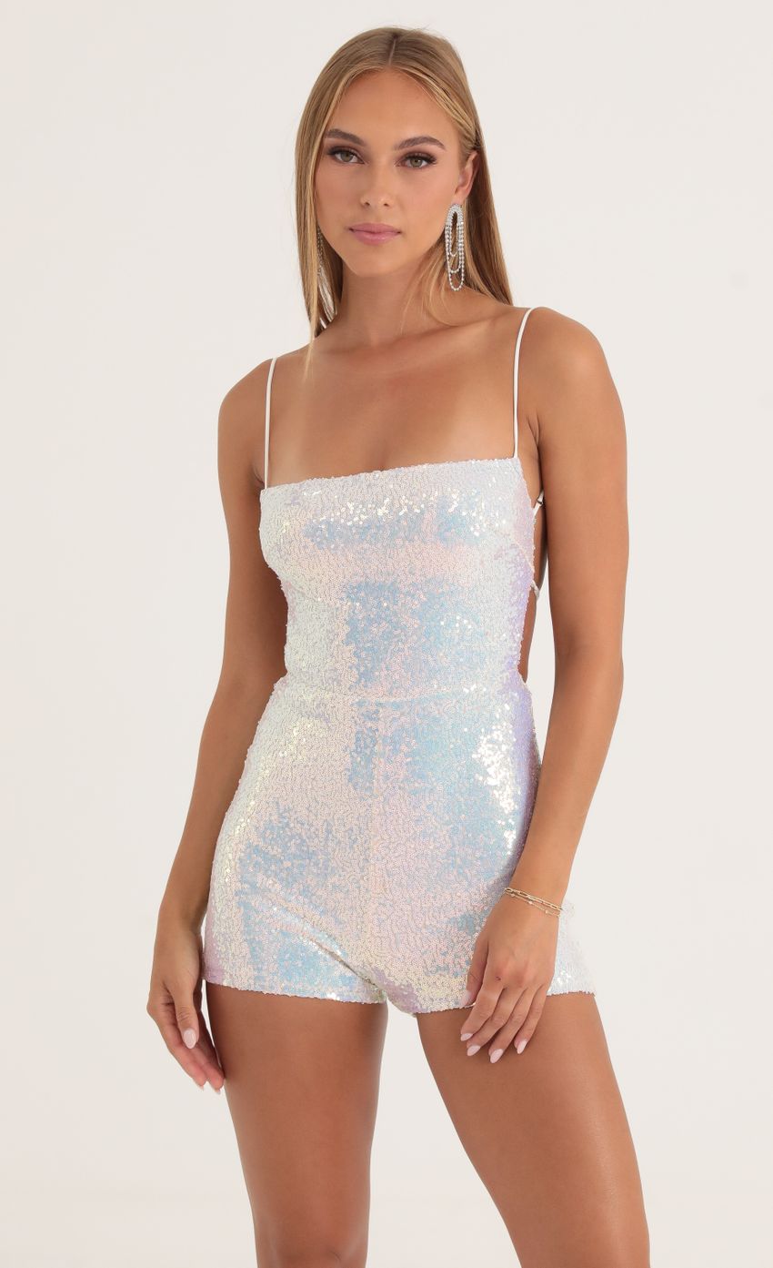 Picture Legacy Iridescent Sequin Open Back Romper in White. Source: https://media-img.lucyinthesky.com/data/Oct22/850xAUTO/ea2b8621-228c-459b-a5f9-085bb8b407b0.jpg